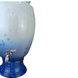 Blue and white drink dispenser with a silver faucet on a white background