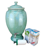 Green ceramic water dispenser with a filter candle and packaging on a white background