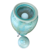 green ceramic water pot with a fluoride filter inside on a white background